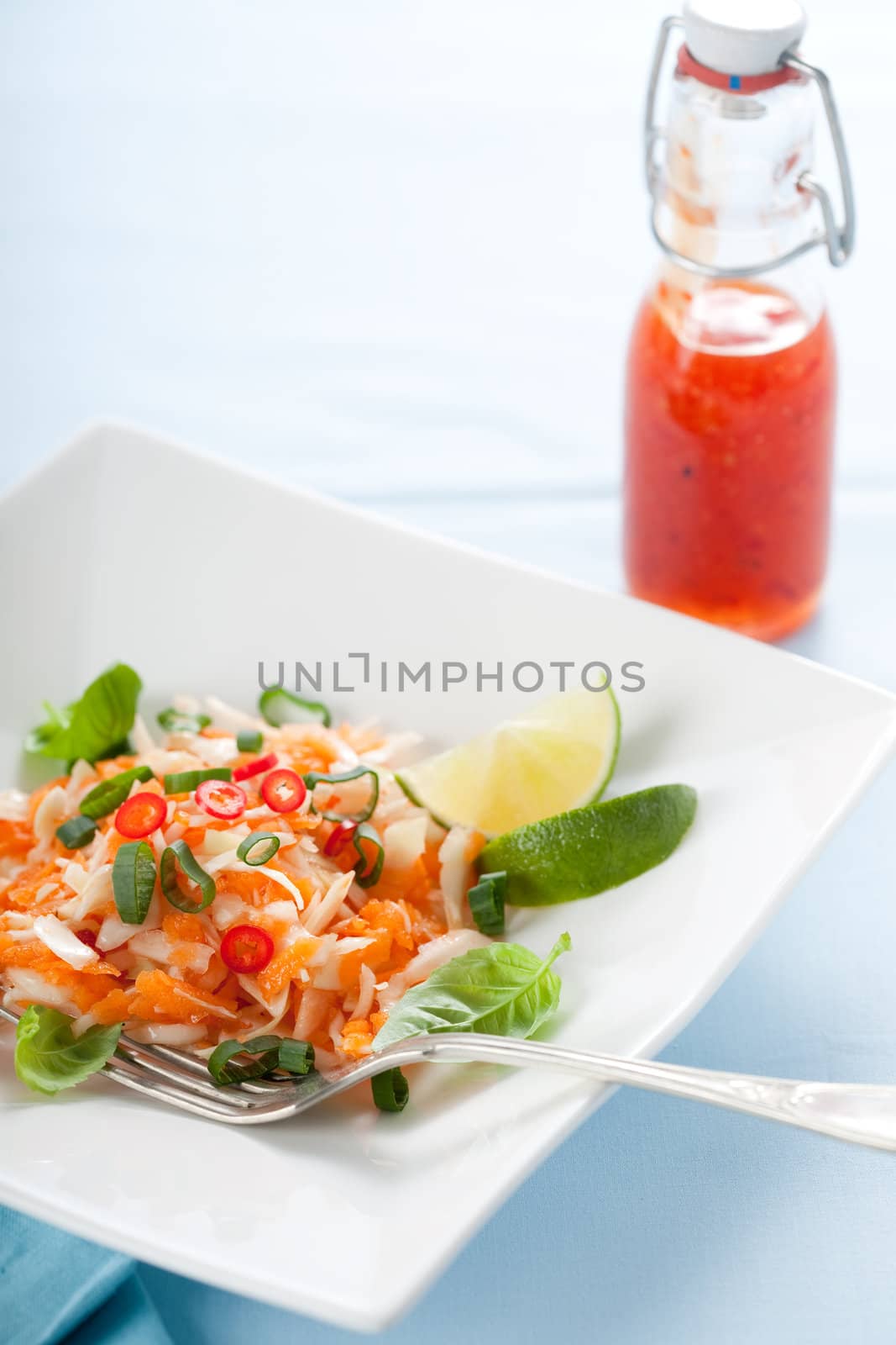Vietnamese carrot salad with chili sauce and lime