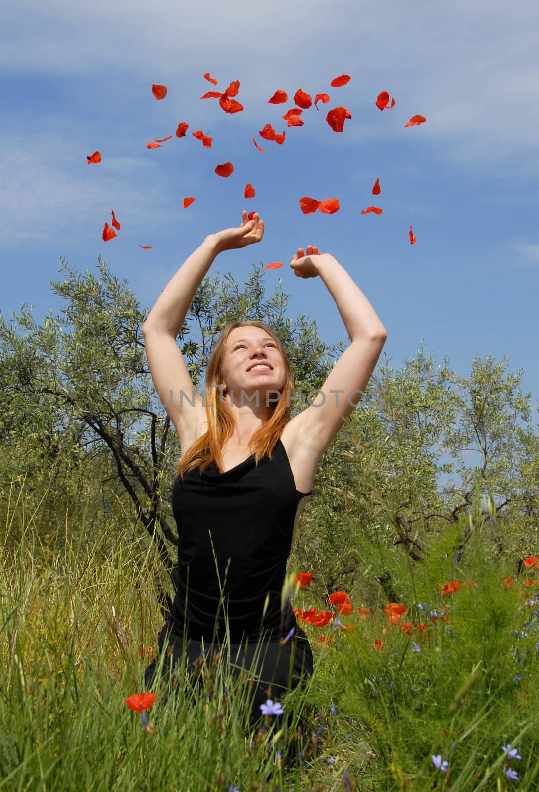 happy  teenager in a field of spring flowers
