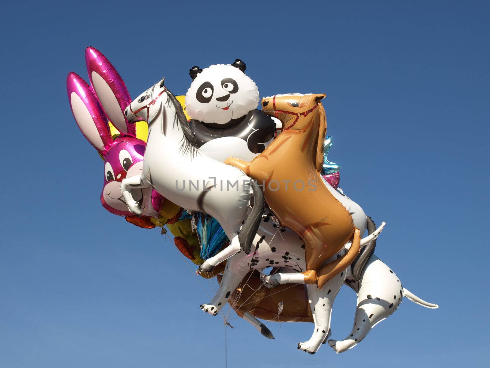 Coloured air balloons toys over blue sky