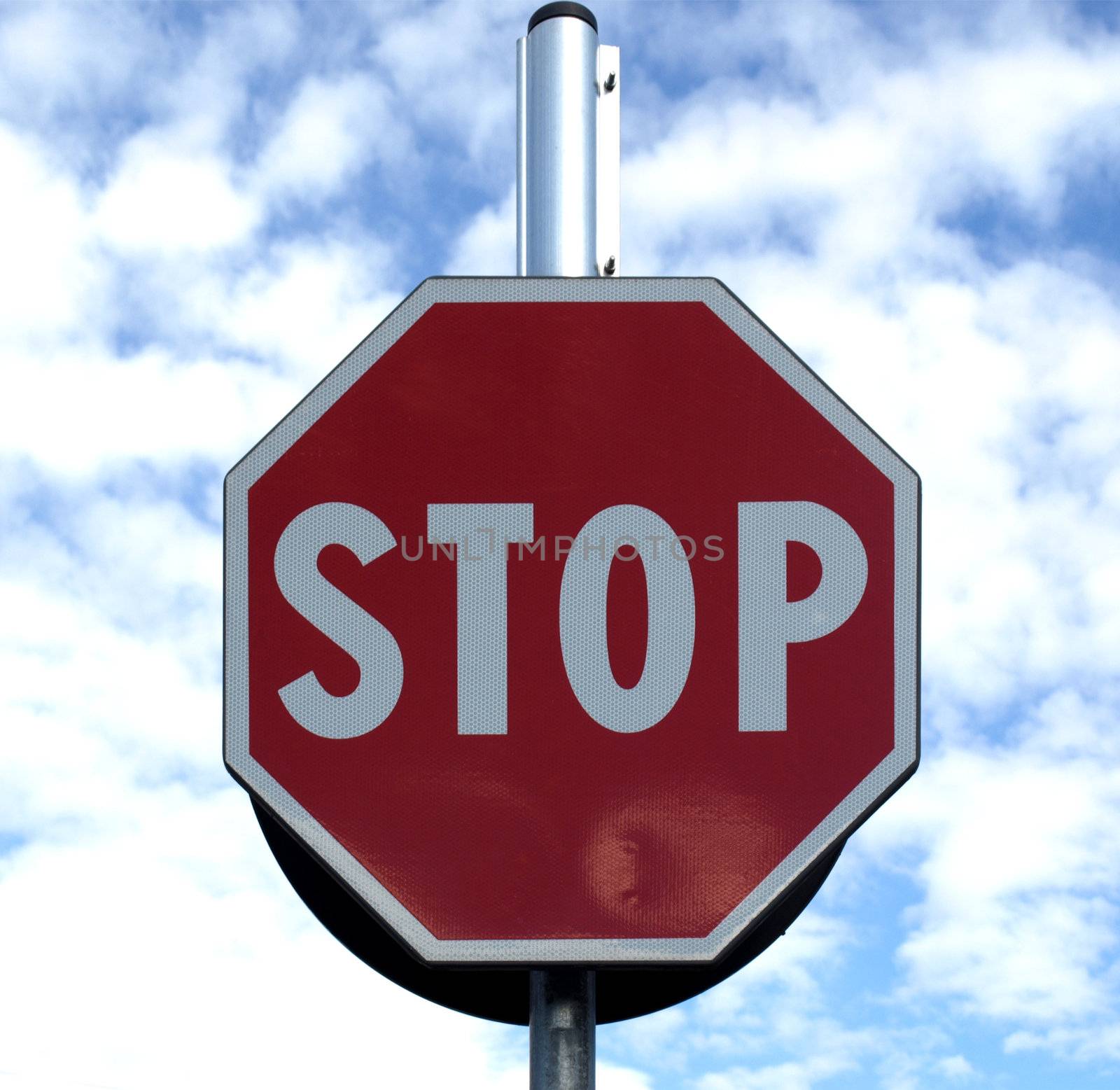 Stop traffic sign over blue sky with clouds