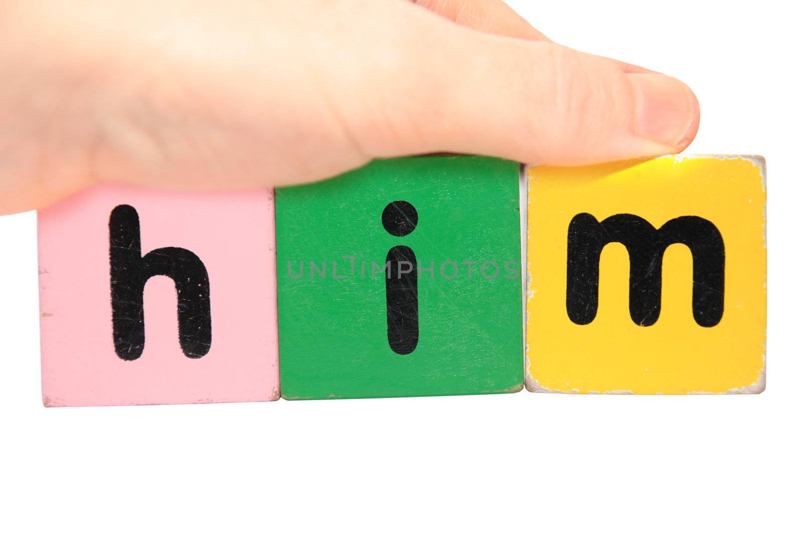 hand holding letter building blocks against a white background that spell him with clipping path