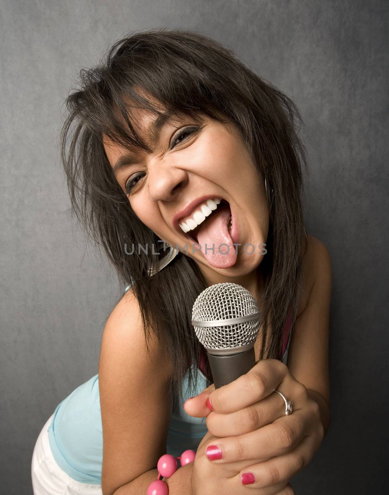 Pretty young singer with a large microphone