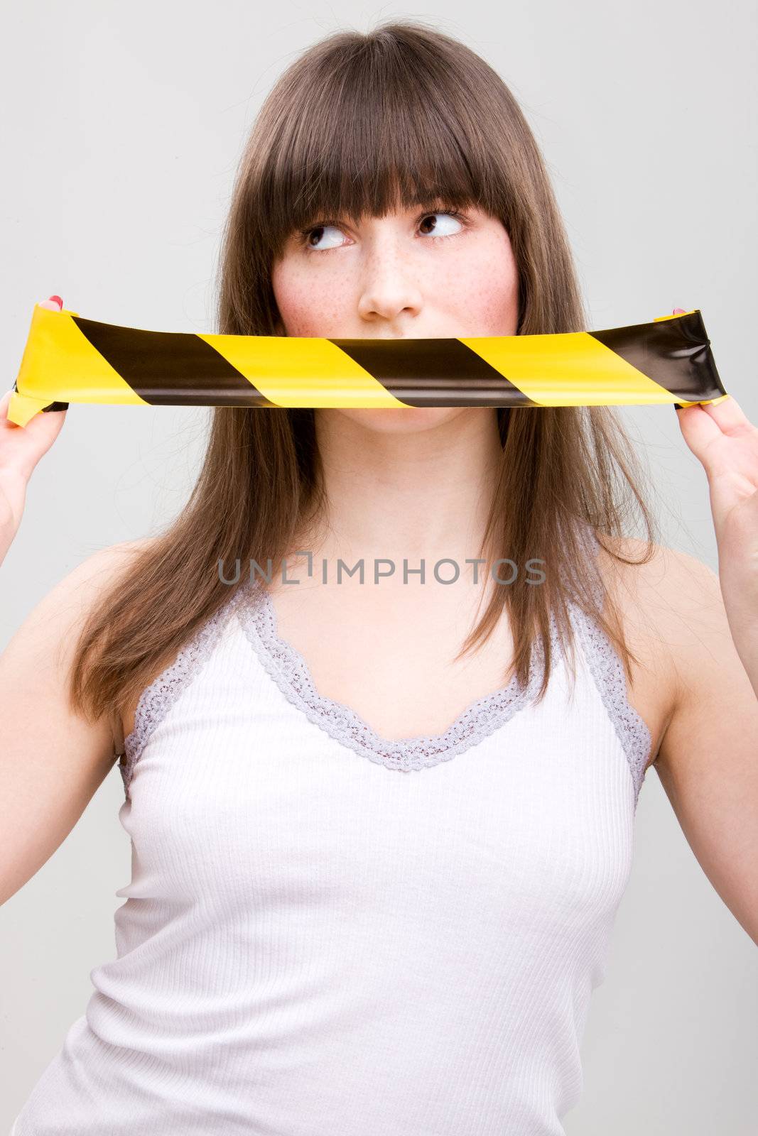 Portrait of young woman with taped mouth