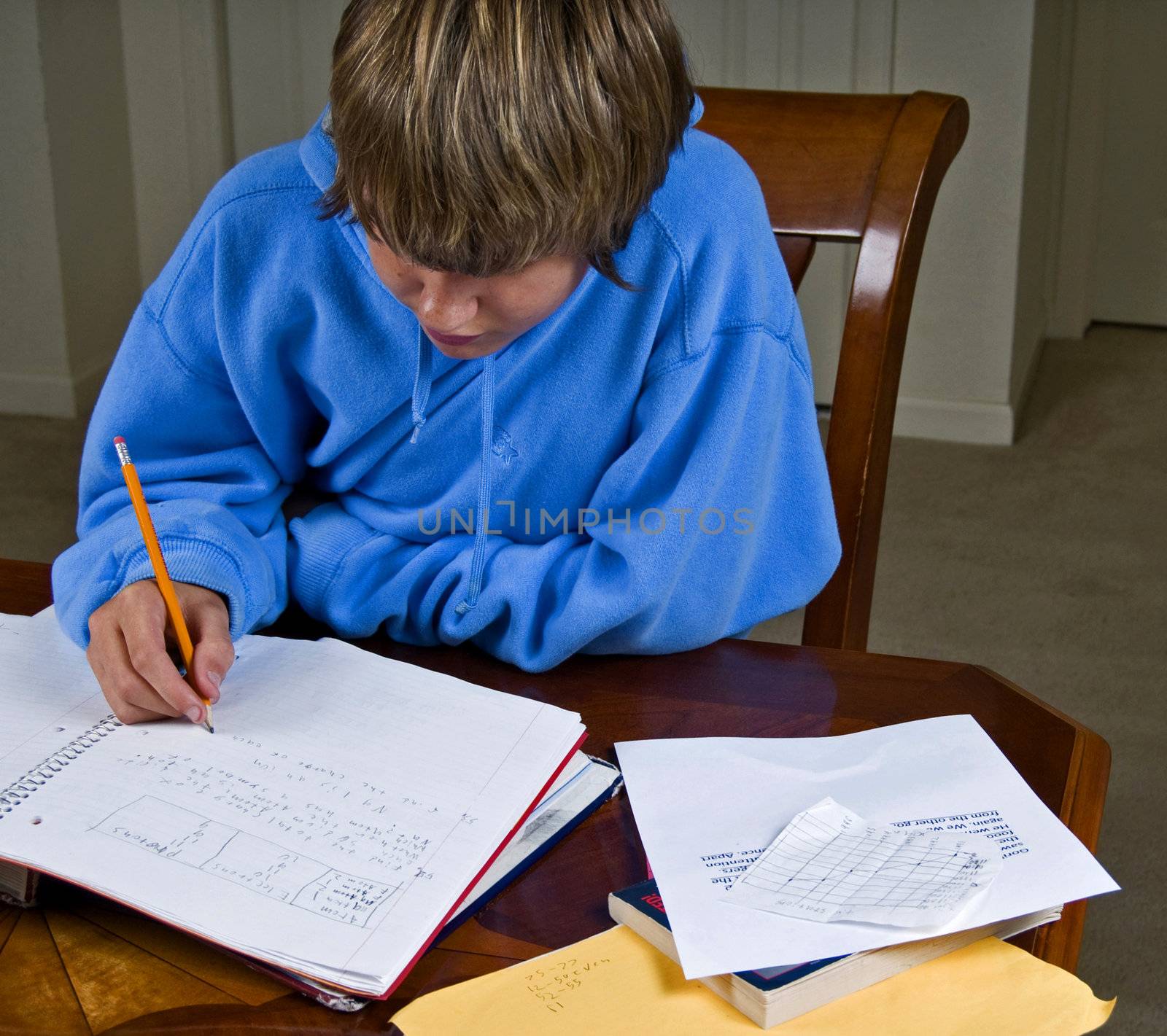Teenage boy working on his algebra homework.