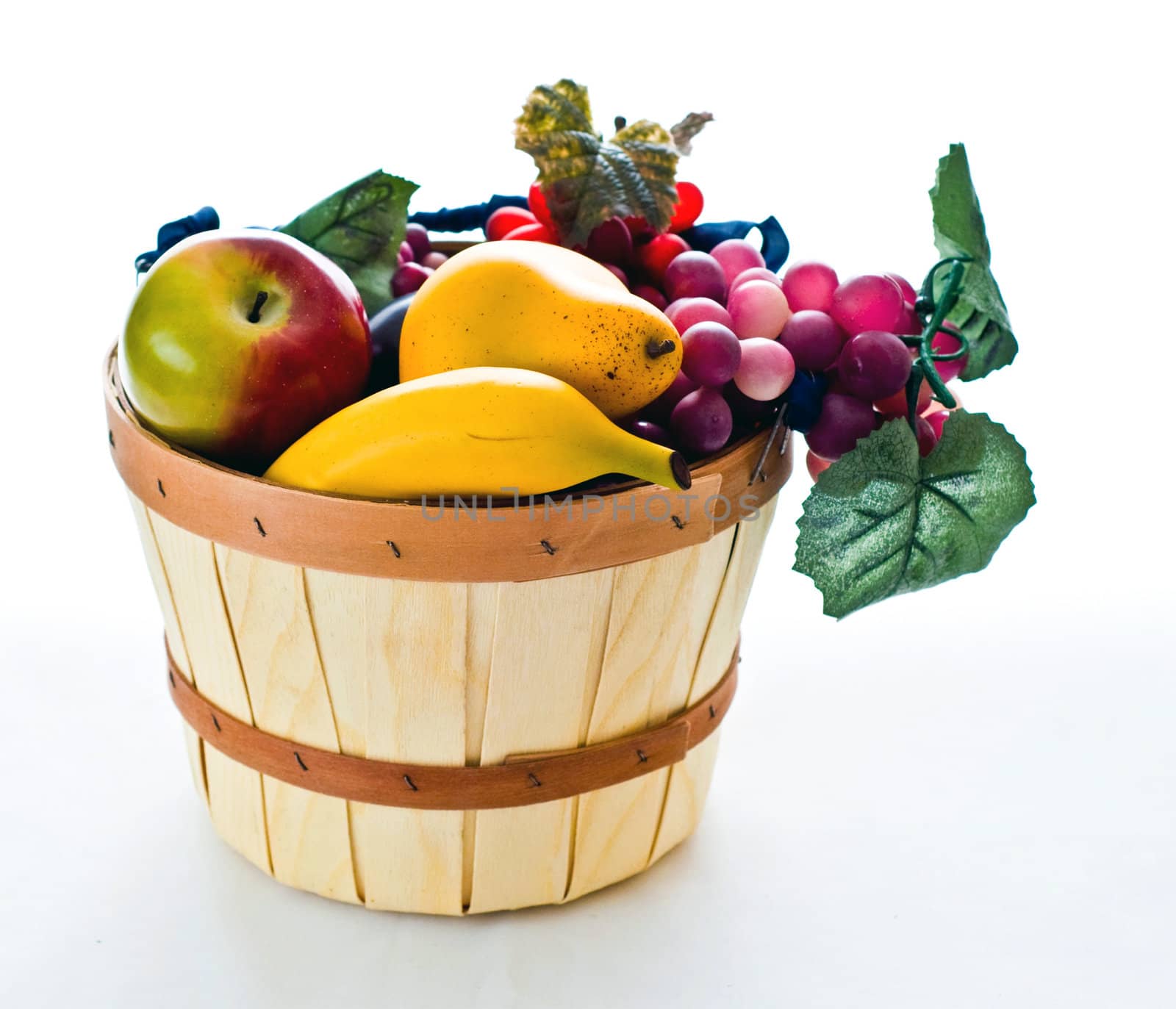 Various types of fruit in a wooden basket as a still life.