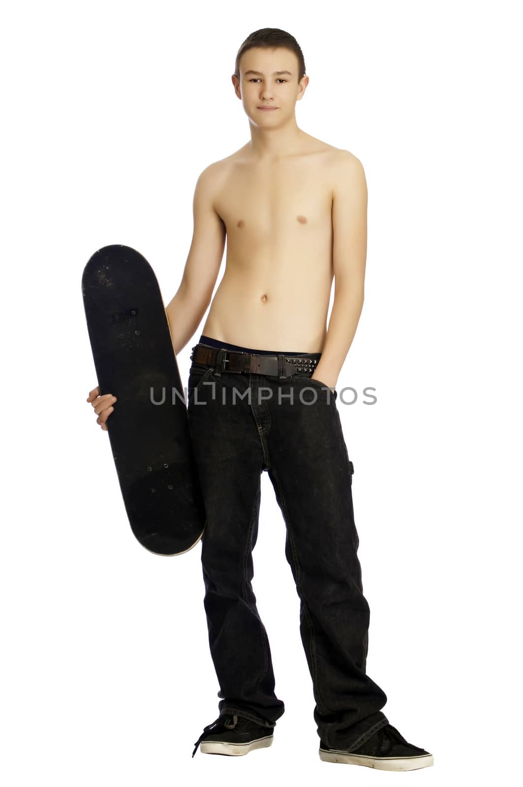 Teenager standing with his skateboard while resting and taking a break.
