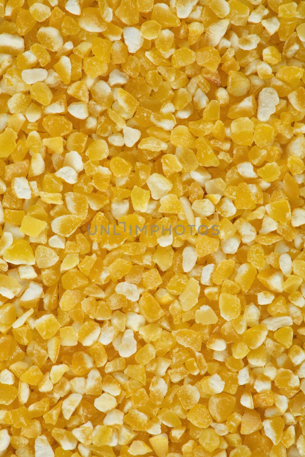 Yellow crushed maize cereals background close up