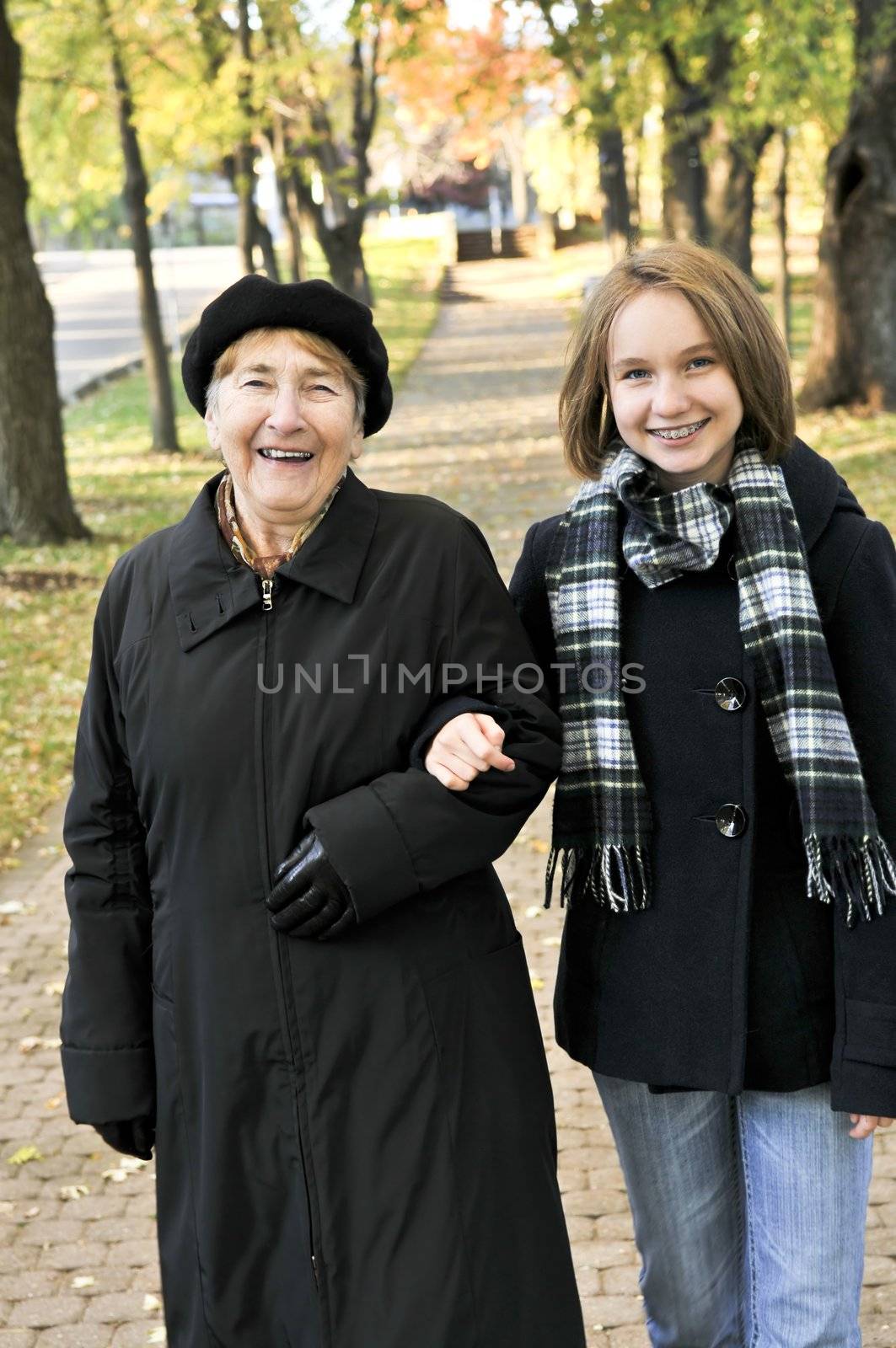 Granddaughter walking with grandmother by elenathewise