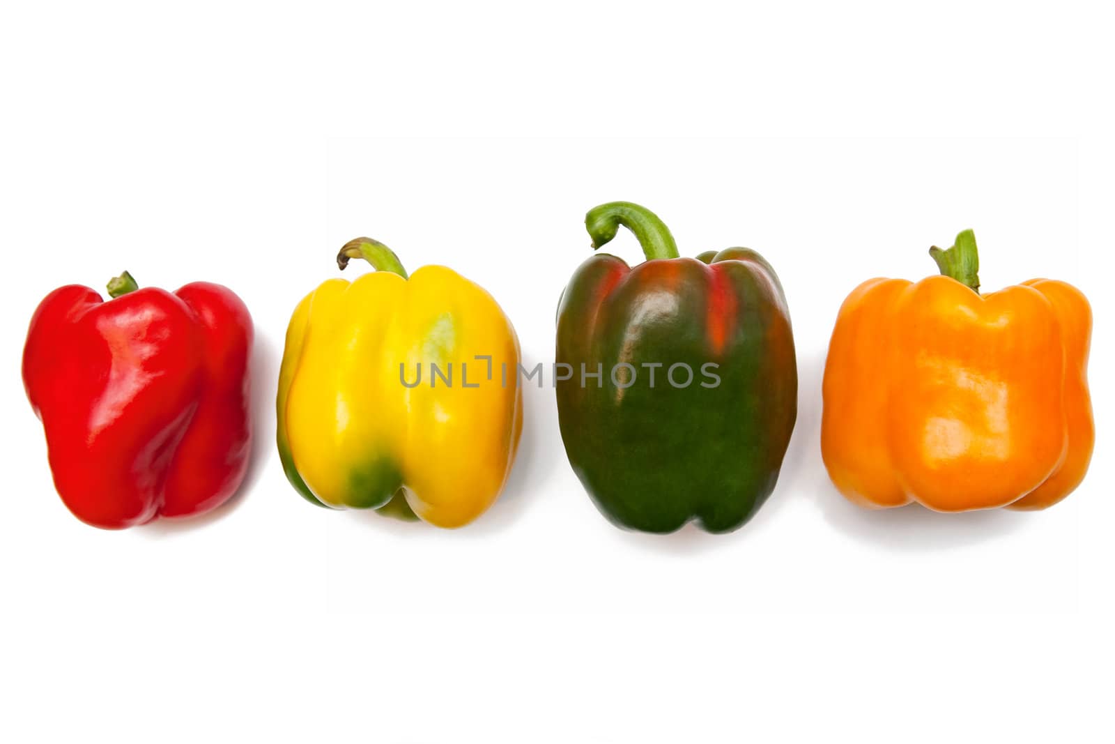 Four colorful peppers isolated on white