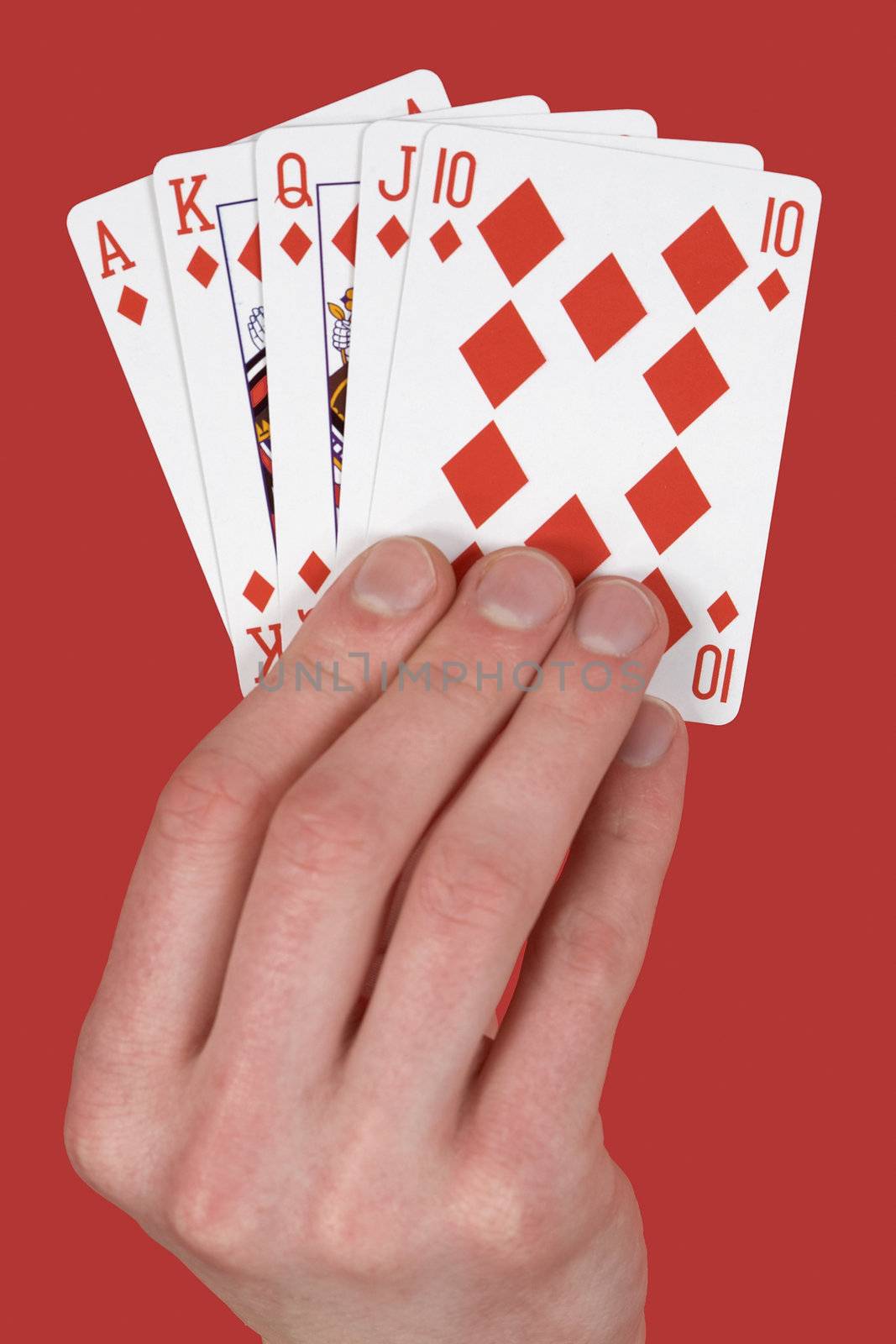 Playing cards single suit in hand on red