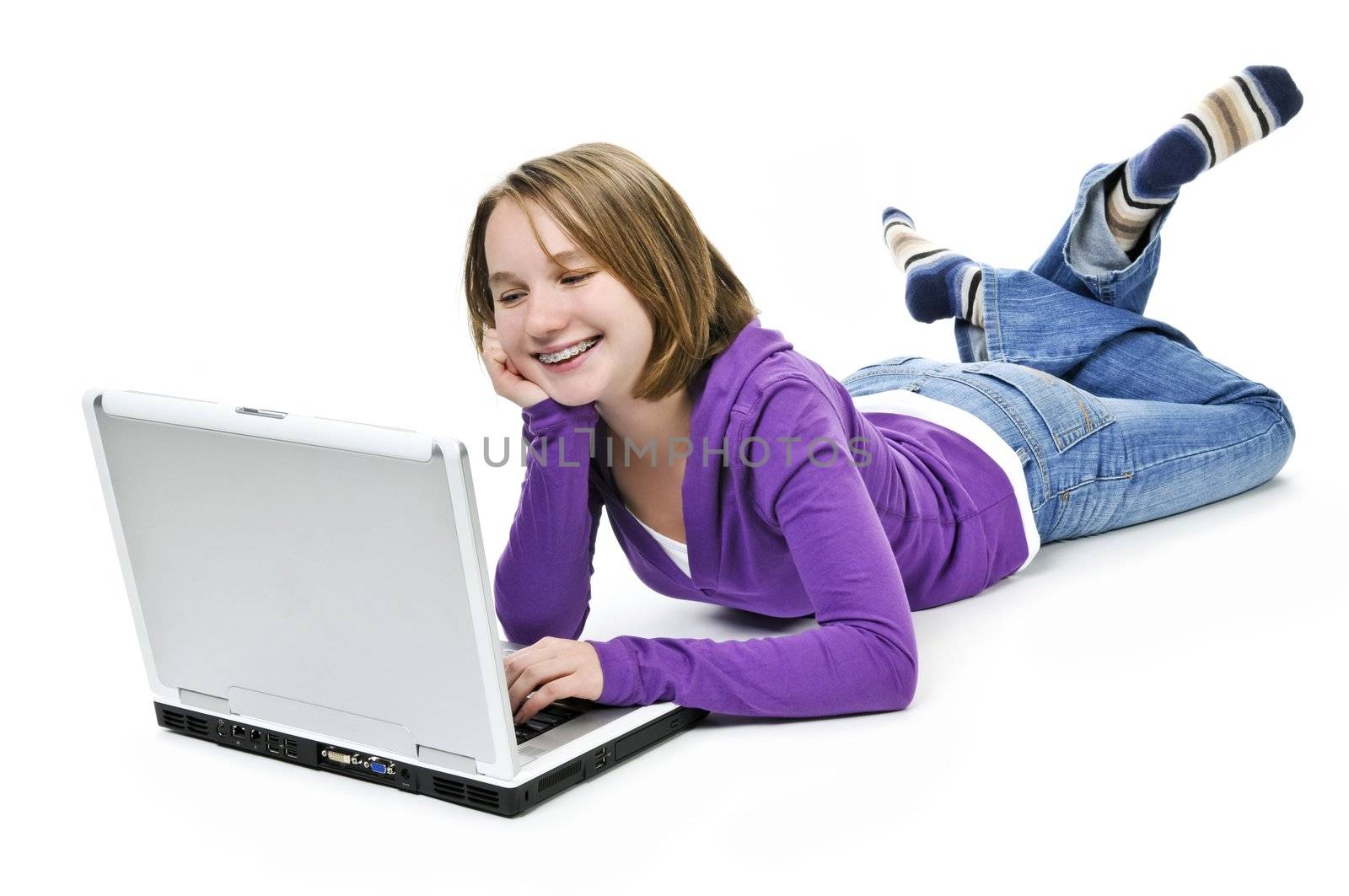 Young girl lying down with laptop computer