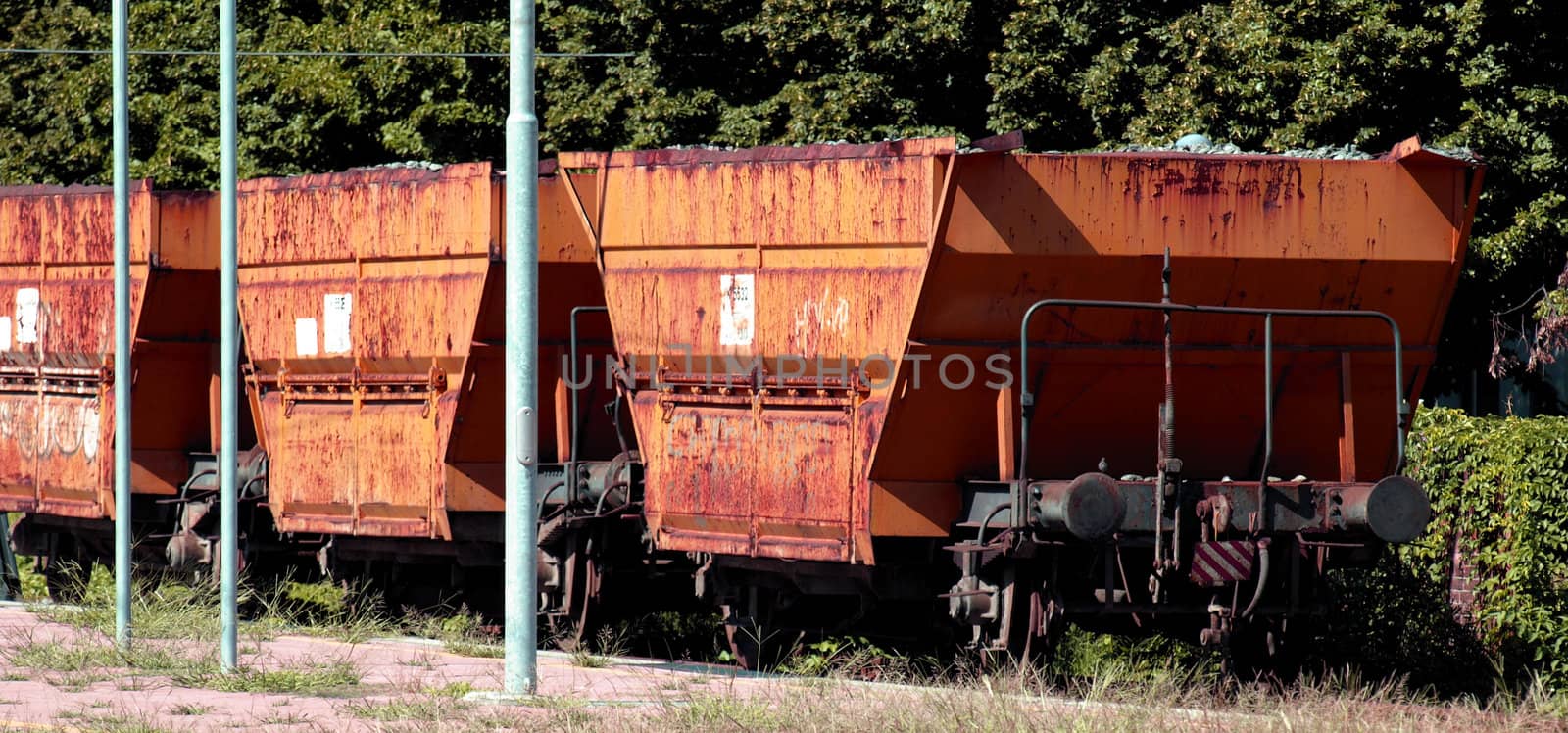 Yellow cargo train wagons at a station