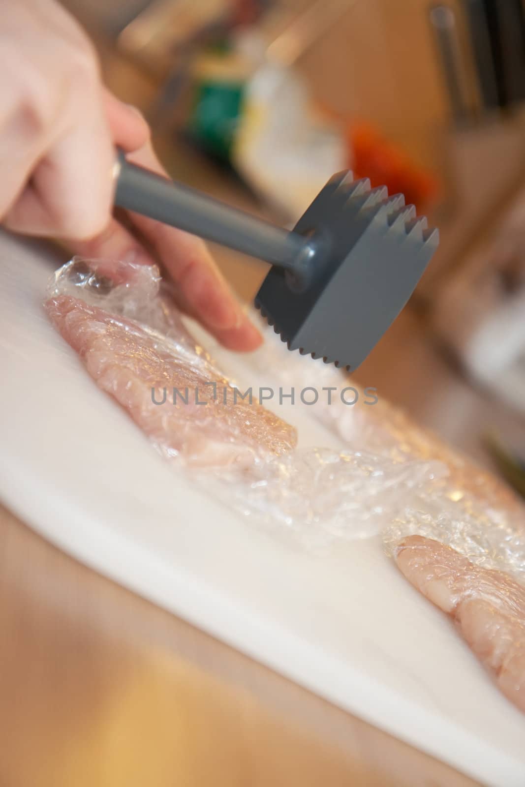 tenderizing meat, motion blur, shallow DOF, close-up