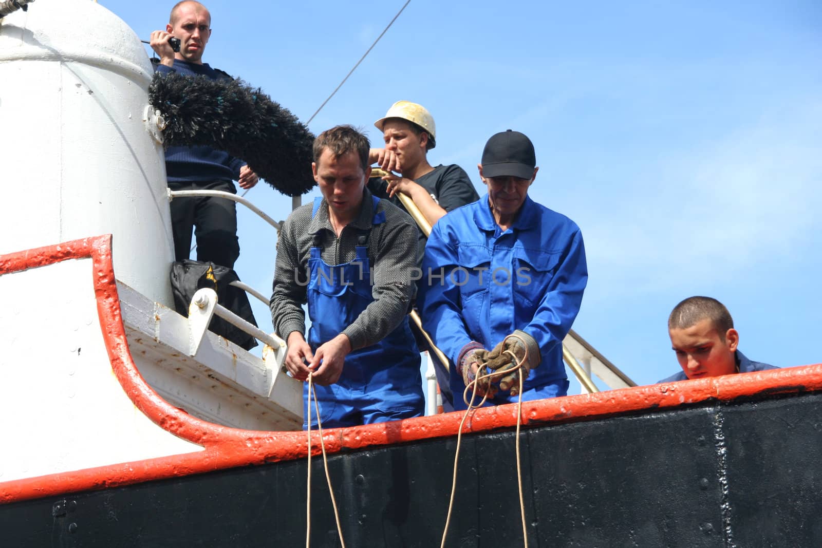 AMSTERDAM, AUGUST 19, 2010: Sailors mooring the Russian tall ship Sedov to the quay at Sail 2010 in Amsterdam, Holland on august 19, 2010