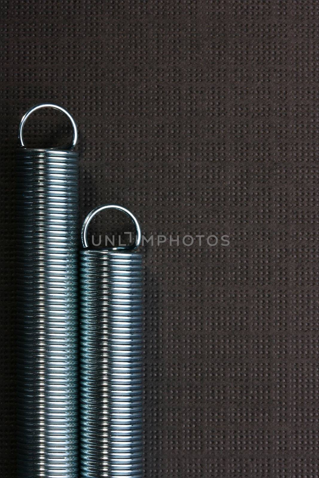 Metal spring deformed on an arch on a blue background.