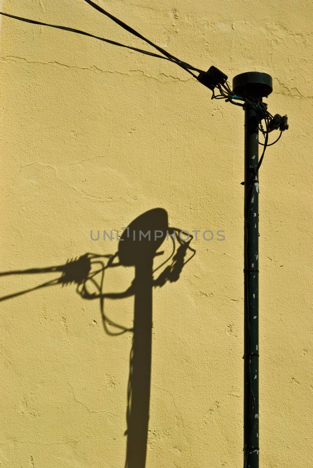 Shadow of a pole on yellow wall, taken on Madeira, Portugal.