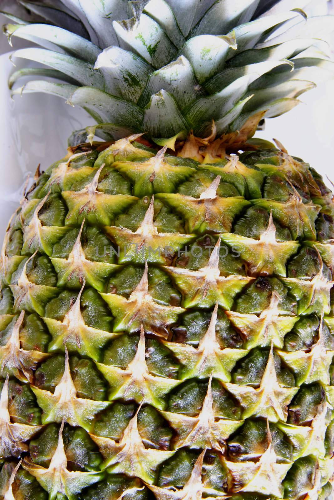 fresh pineapple on a plate ready to be cut