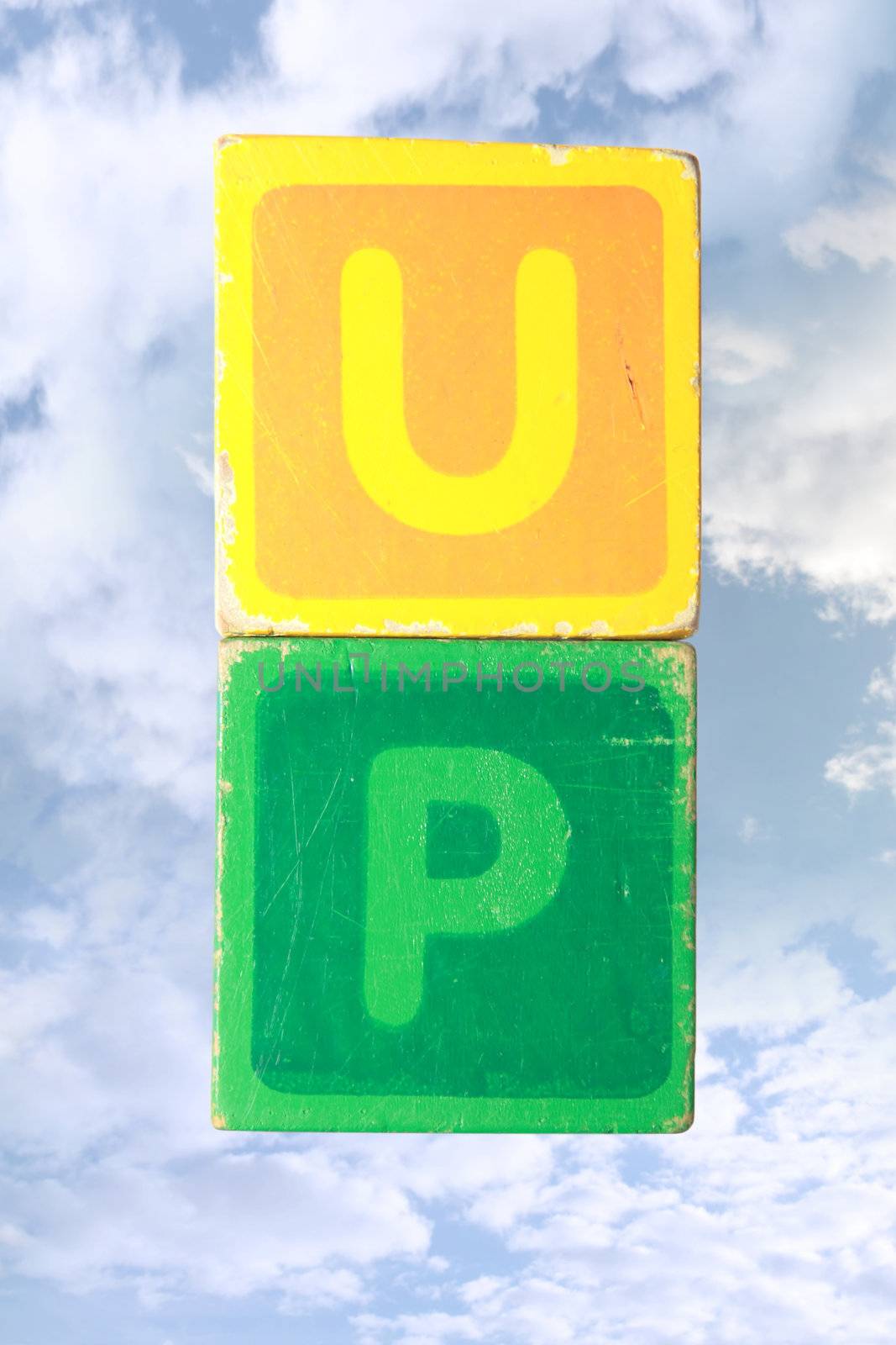 toy letters that spell up against a cloudy background with clipping path