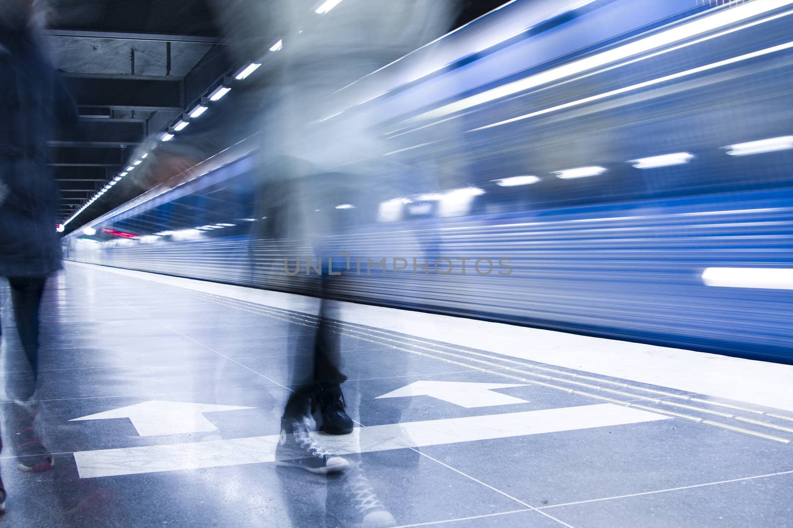 Blurred advancing people at the subway station