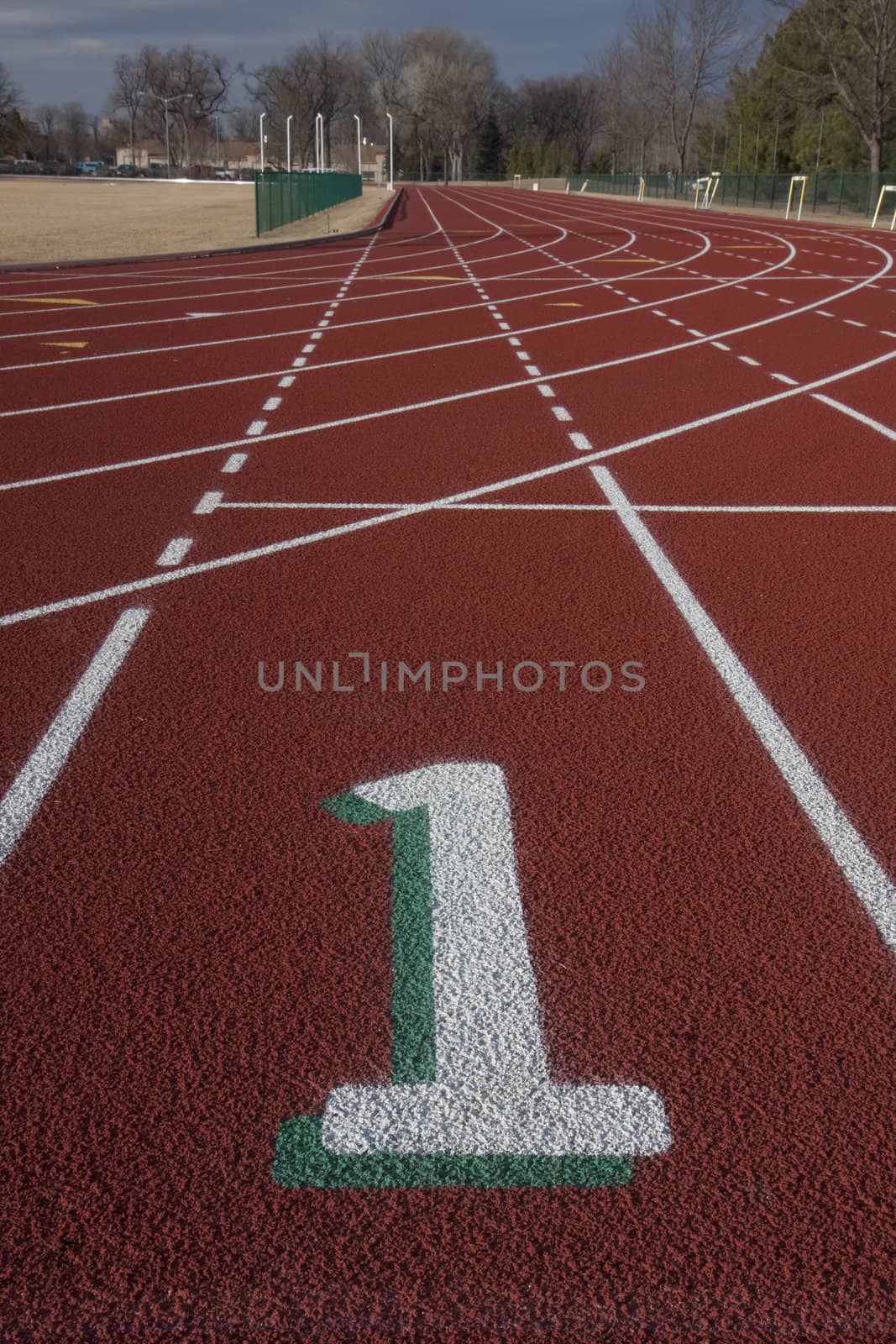 white lane number one at a starting line red running tracks