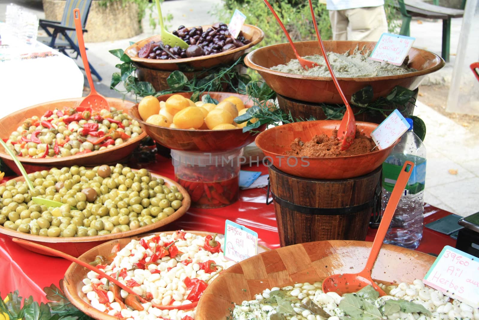 A variety of French delicacies like olives, tapenade and marinated garlic on a local market in Bedoin, France 