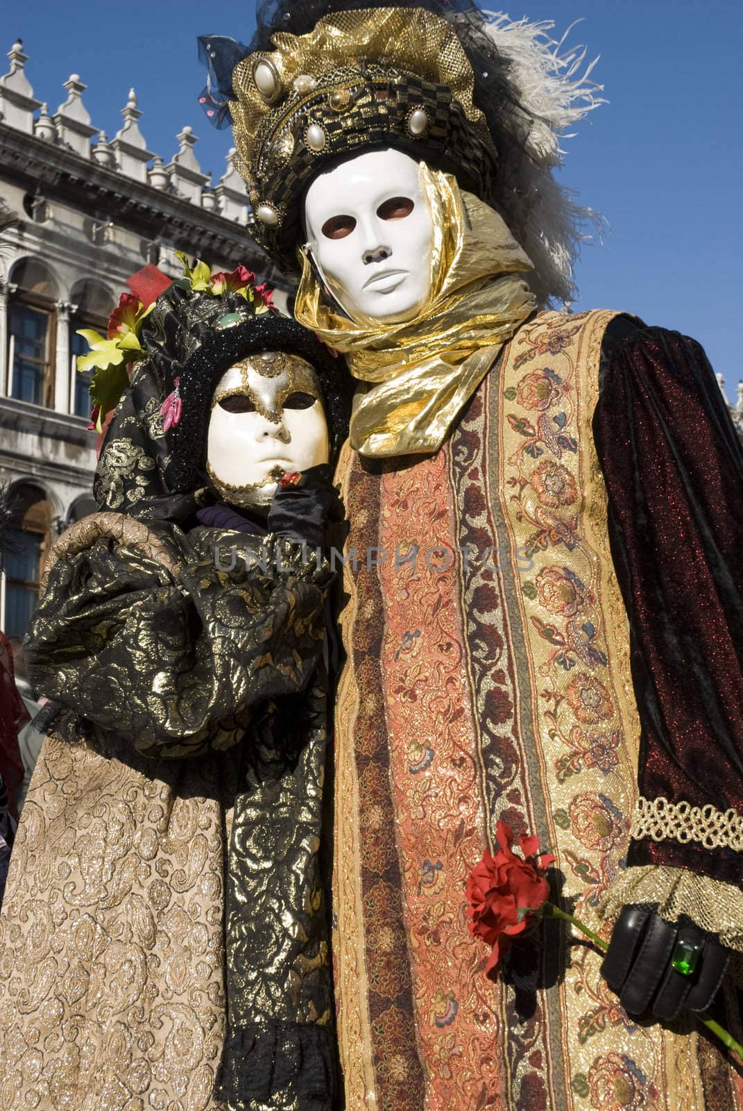 Traditionally dressed Venice carnival couples in Piazza San Marco, Italy