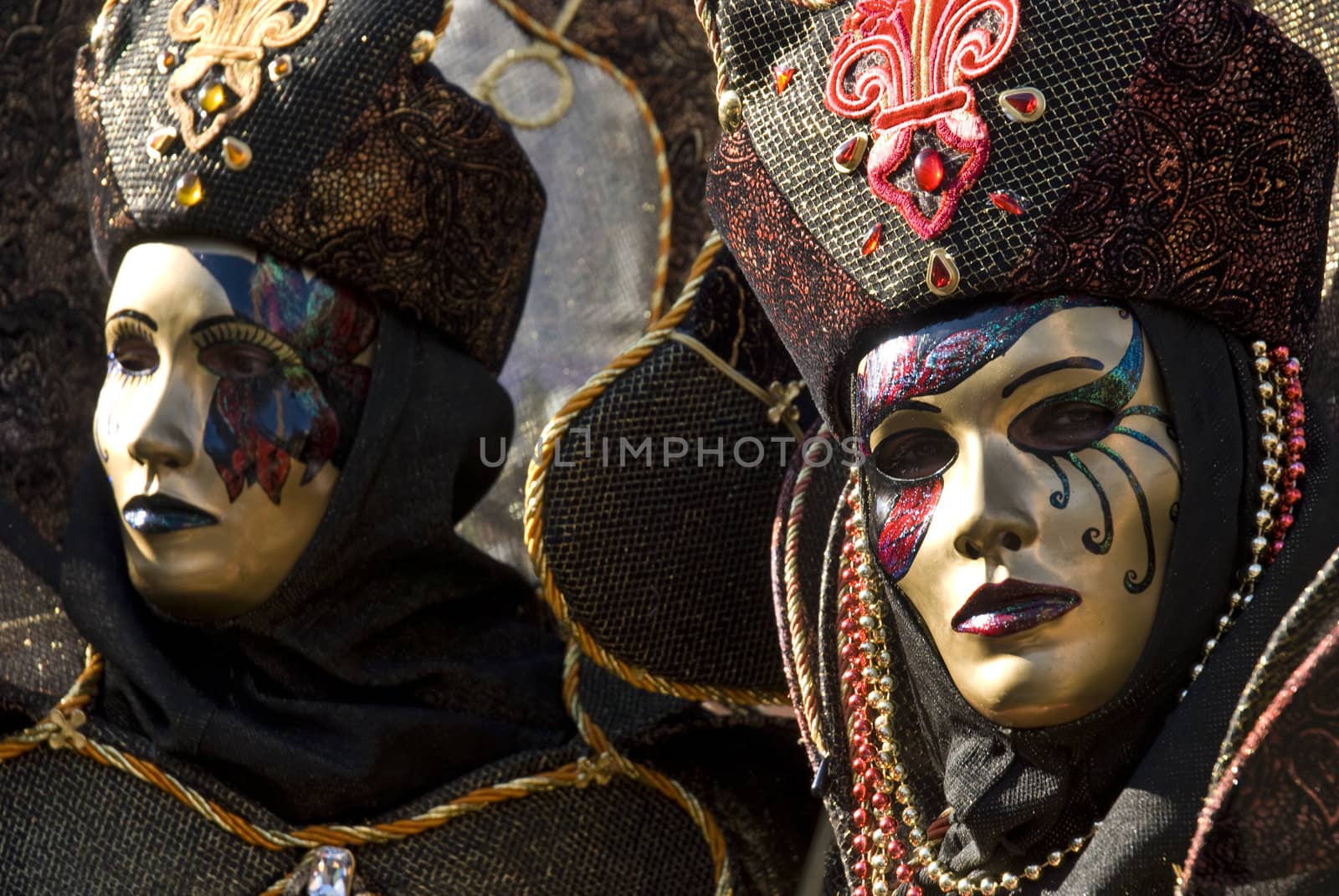 Traditionally dressed Venice carnival couples in Piazza San Marco, Italy