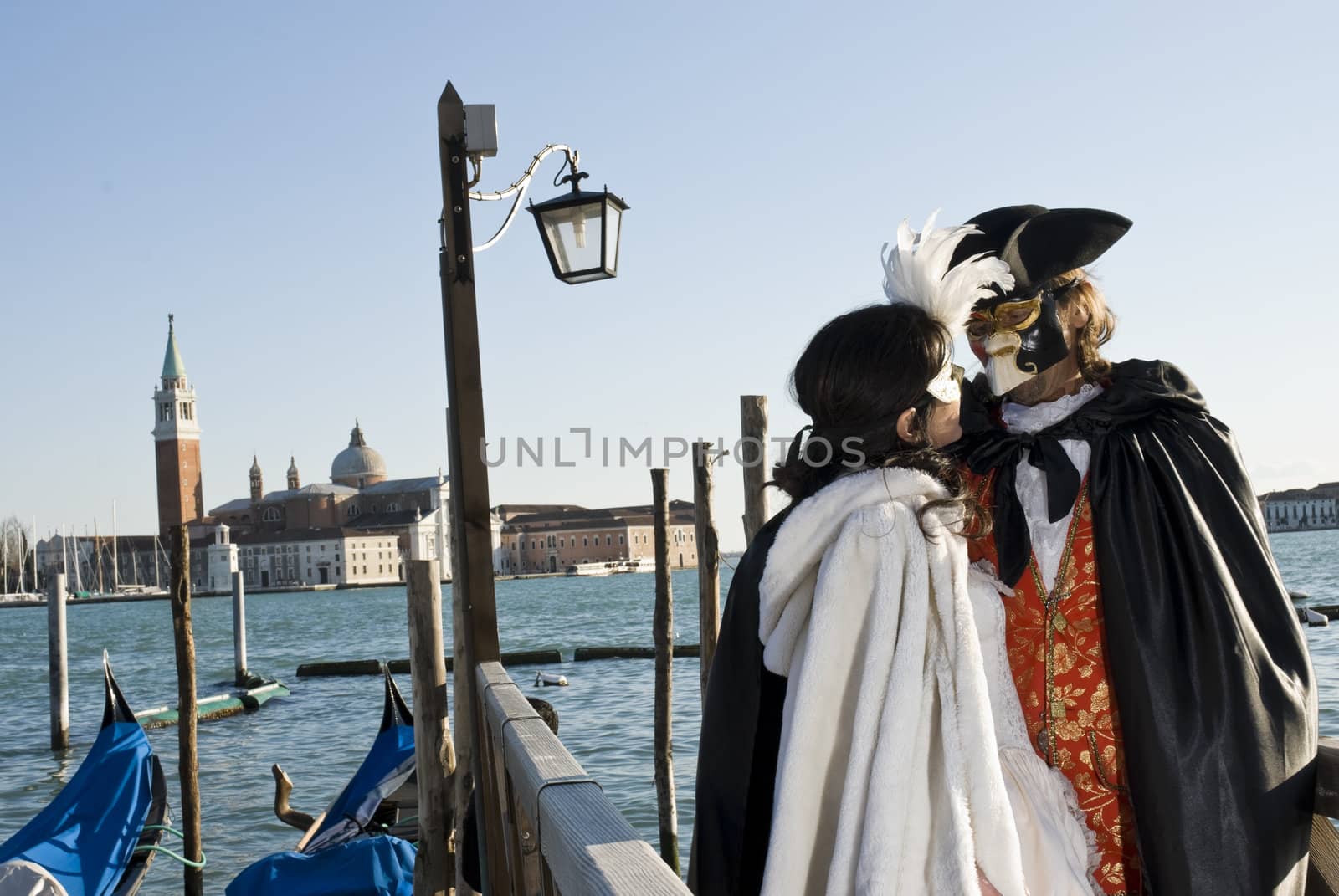 Traditionally dressed Venice carnival couples in Piazza San Marco, Italy
