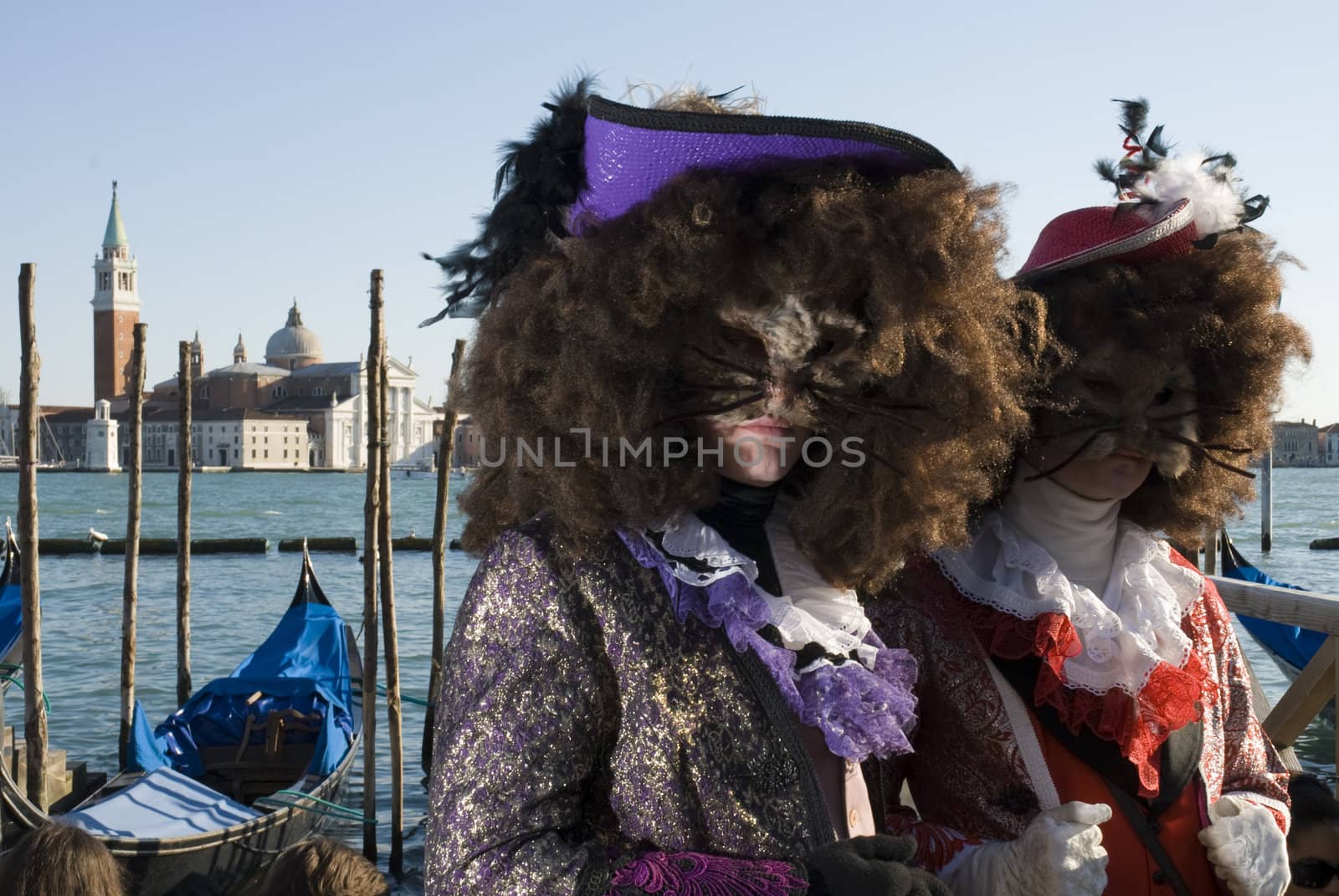Traditionally dressed Venice carnival couples in Piazza San Marco, Italy