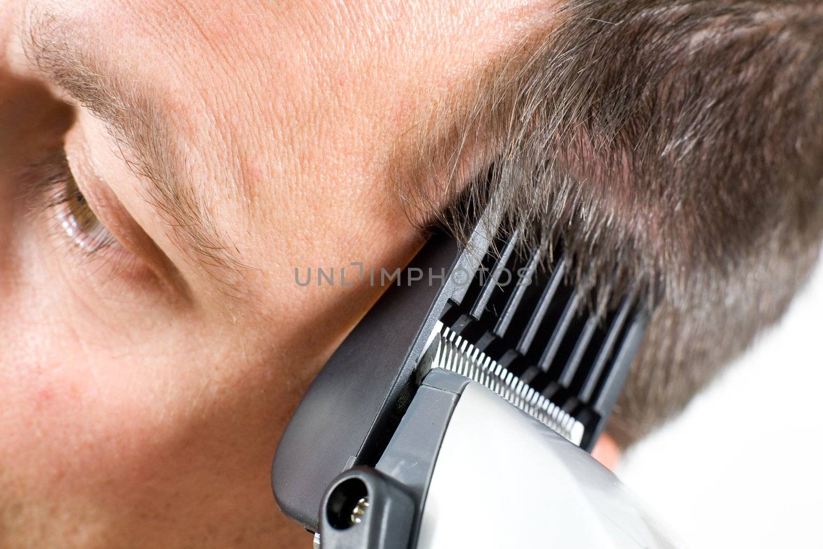 A man getting a haircut with clippers