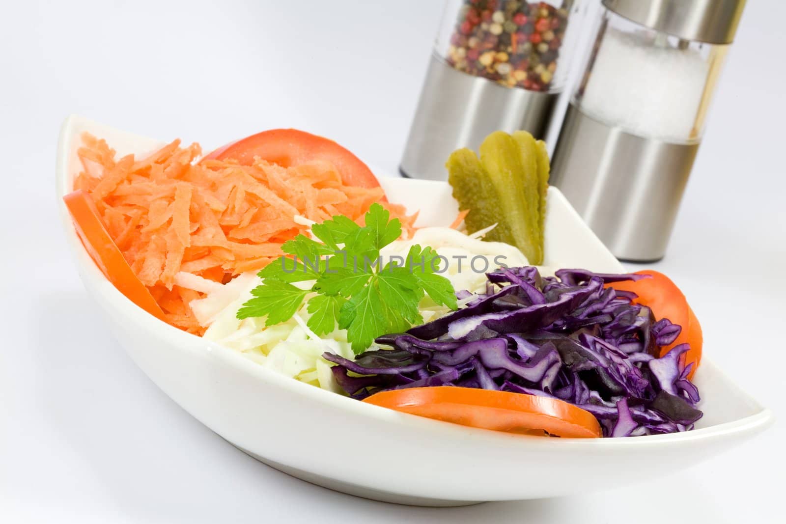 Mixed vegetables in a bowl with salt and pepper