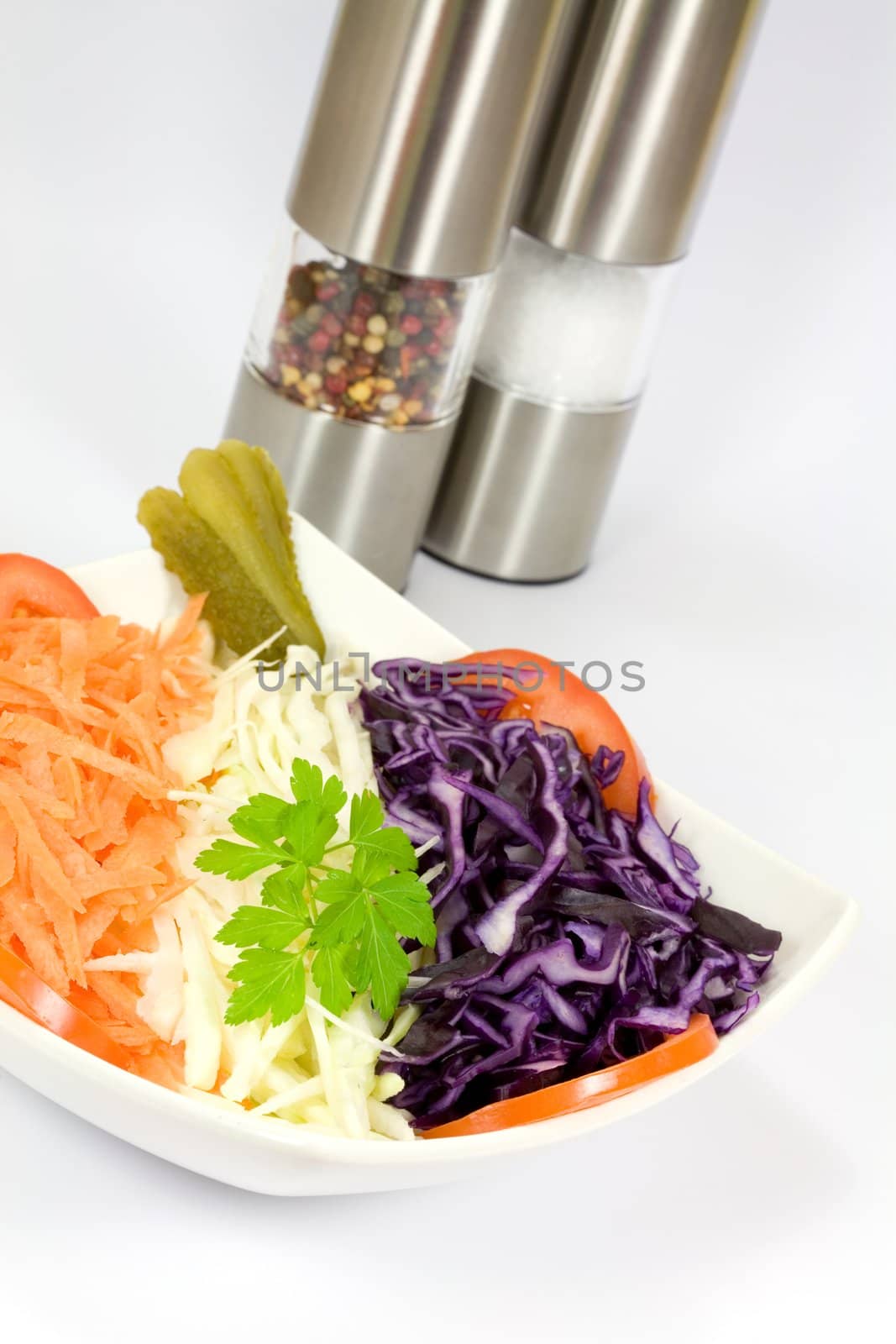 Mixed vegetables in a bowl with salt and pepper