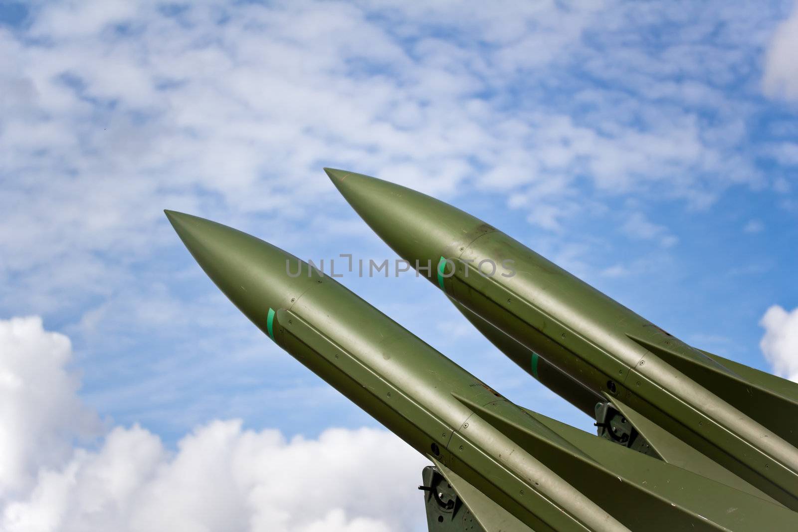 Photograph of two missiles aimed towards the sky during peace time.