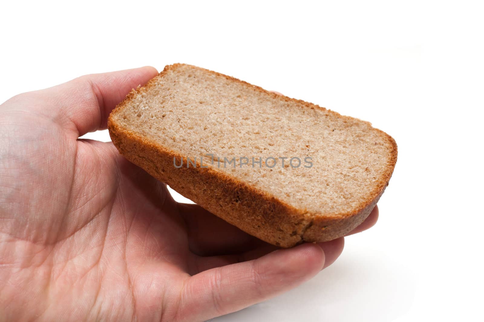Piece of the pumpernickel in hand insulated on white background