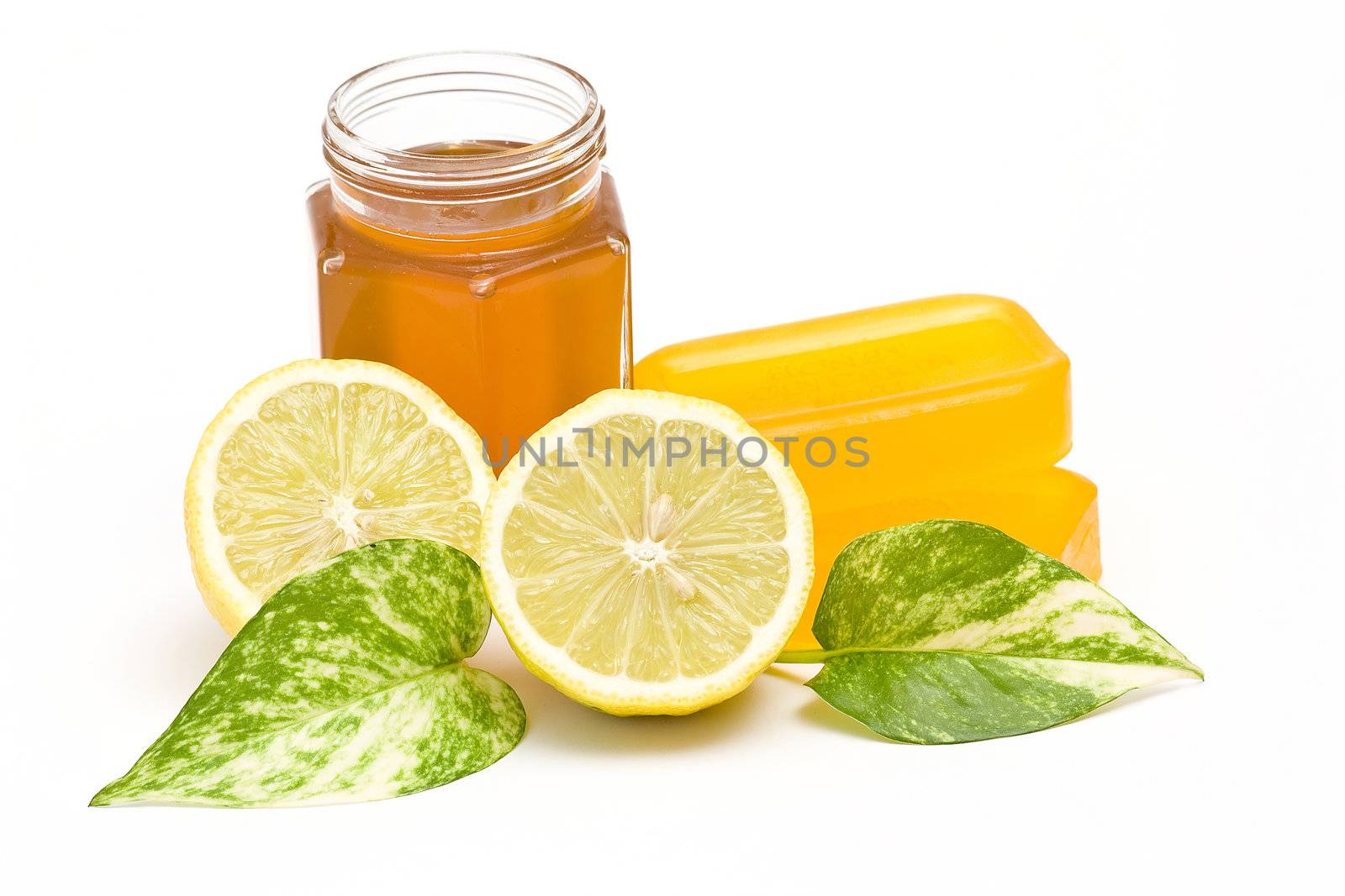 glycerin soap, jar of honey and lemon  by miradrozdowski