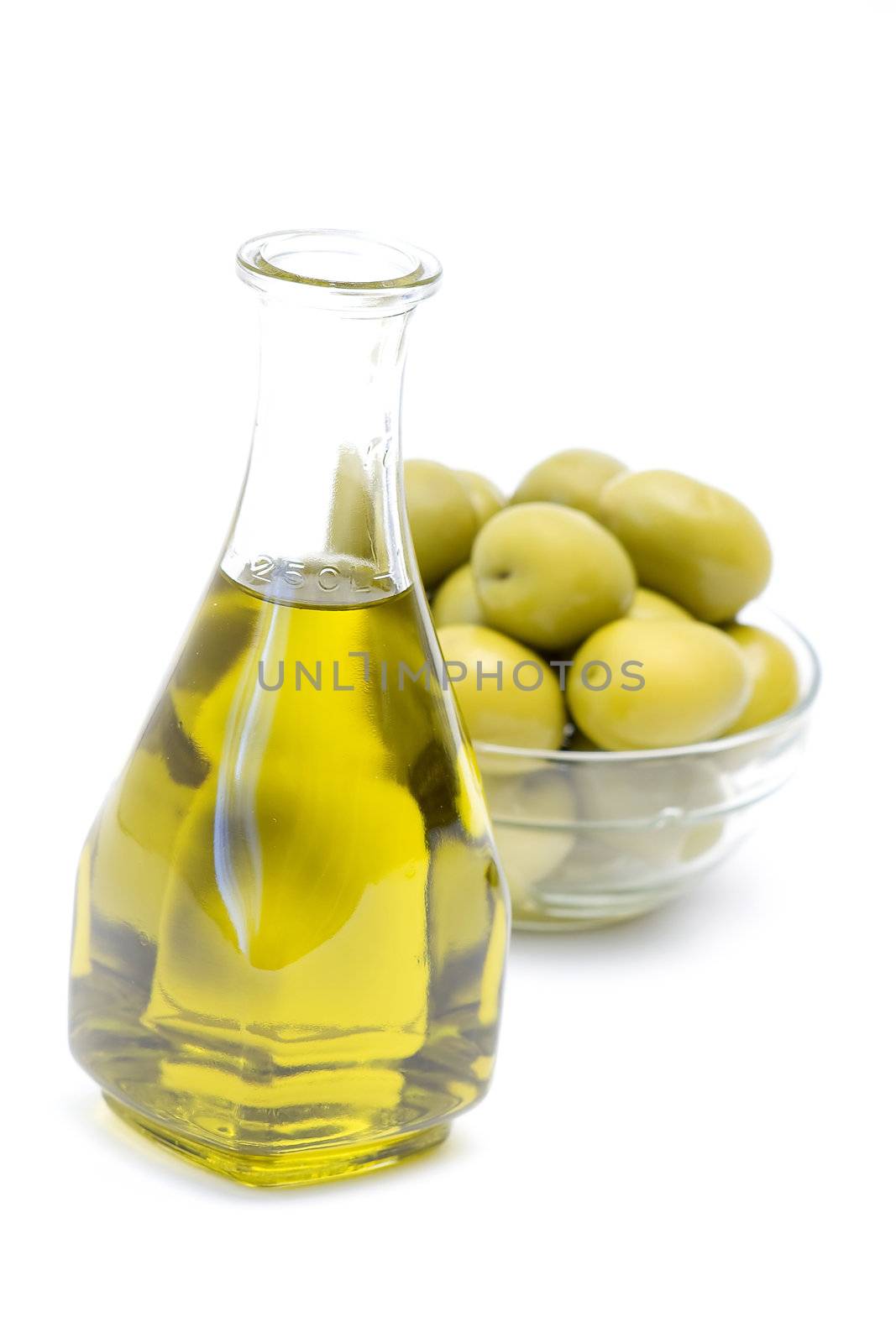 a bottle of olive oil with olives 