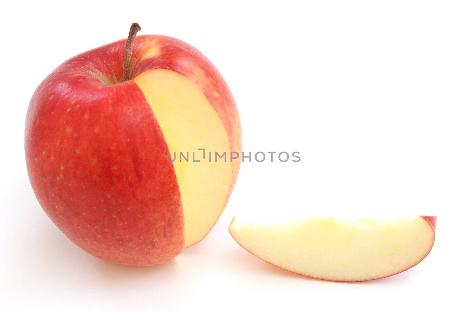 A slice out of a bright red apple.