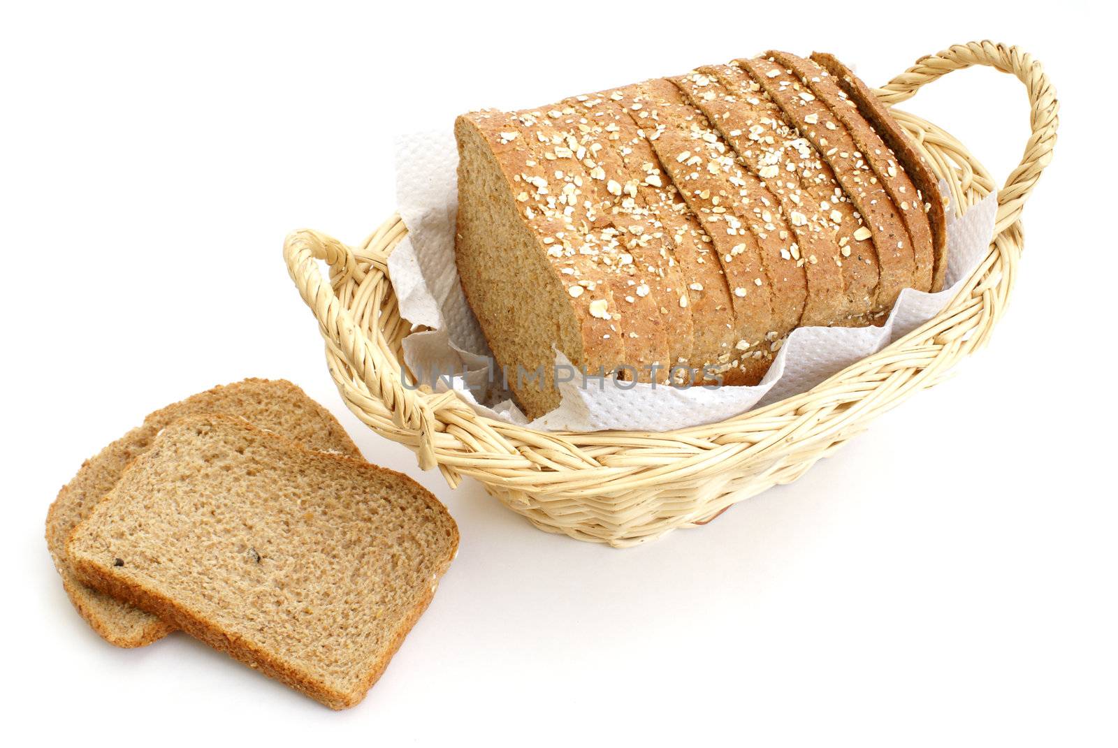 A loaf of honey and oats bread in a basket.