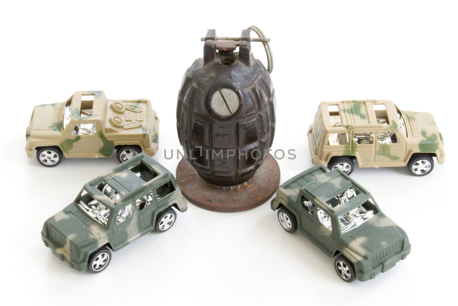 Four toy military vehicles surround a hand grenade.