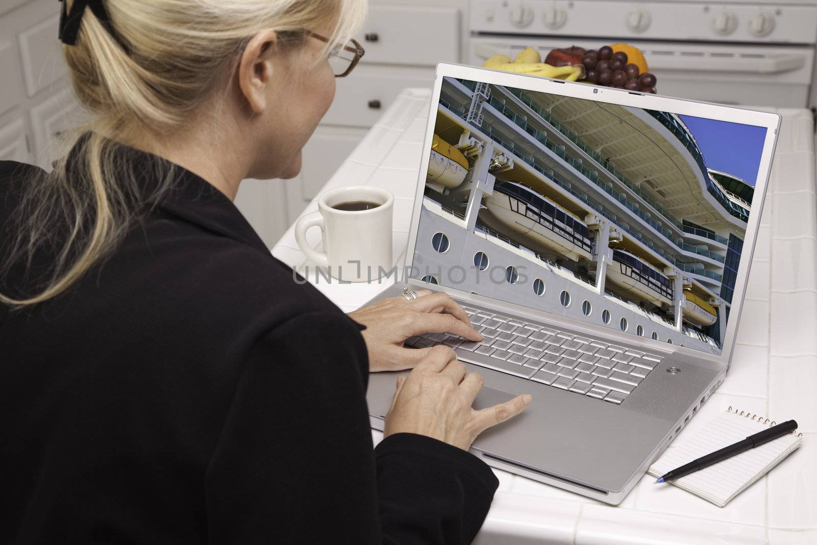 Woman In Kitchen Using Laptop- Cruise vacation by Feverpitched