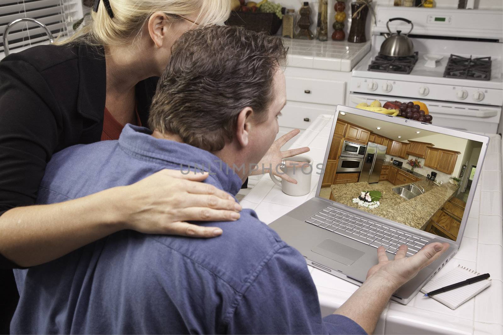 Couple In Kitchen Using Laptop - Home Improvement by Feverpitched