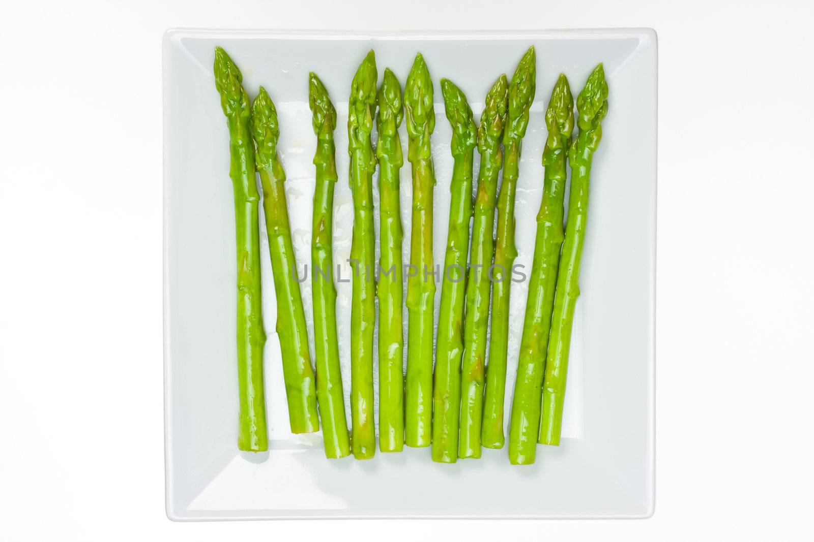 fresh green asparagus isolated on white background by bernjuer
