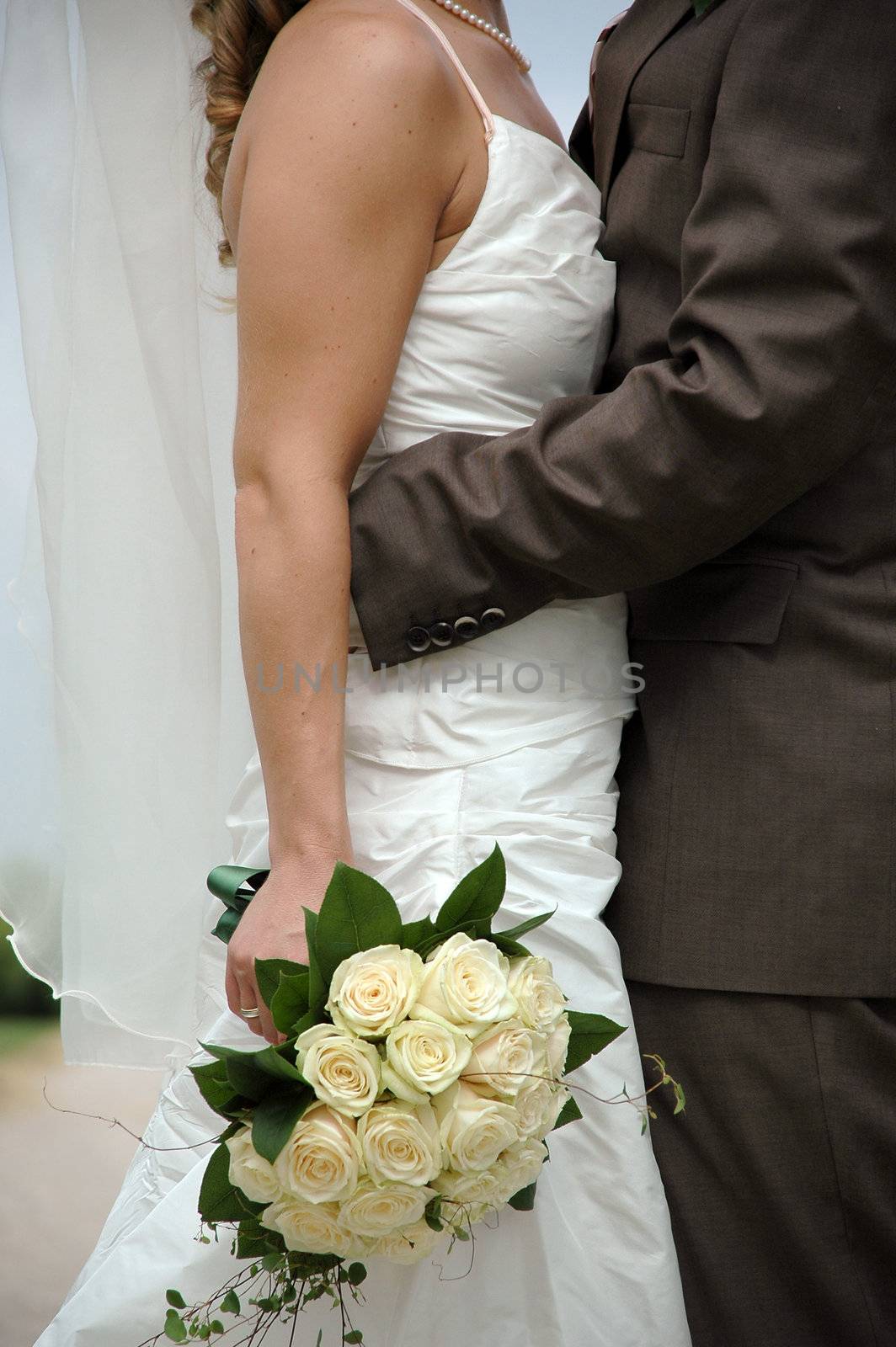 Wedding couple standing very close.