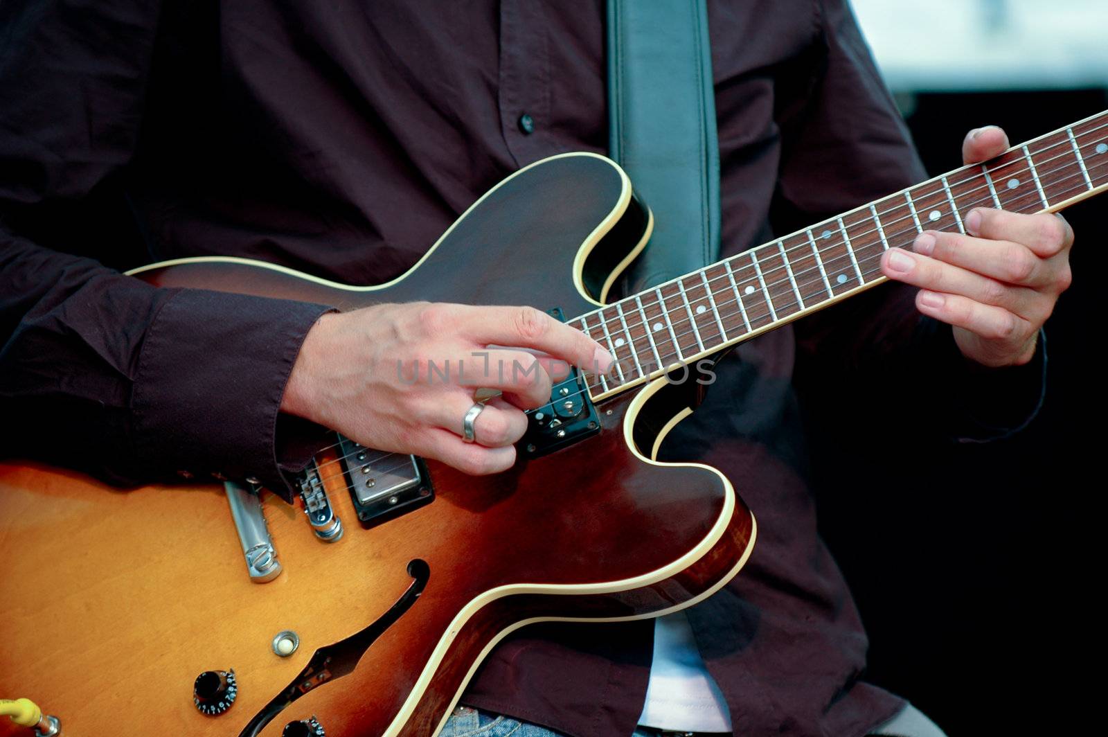 A man is playing his guitar.