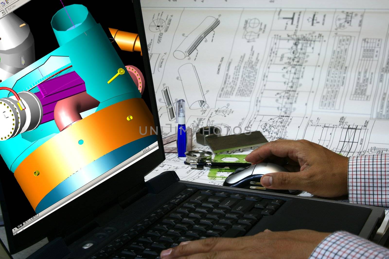 Mechanical engineer designing a pressure vessel. Note 3d display in the monitor is my original works.