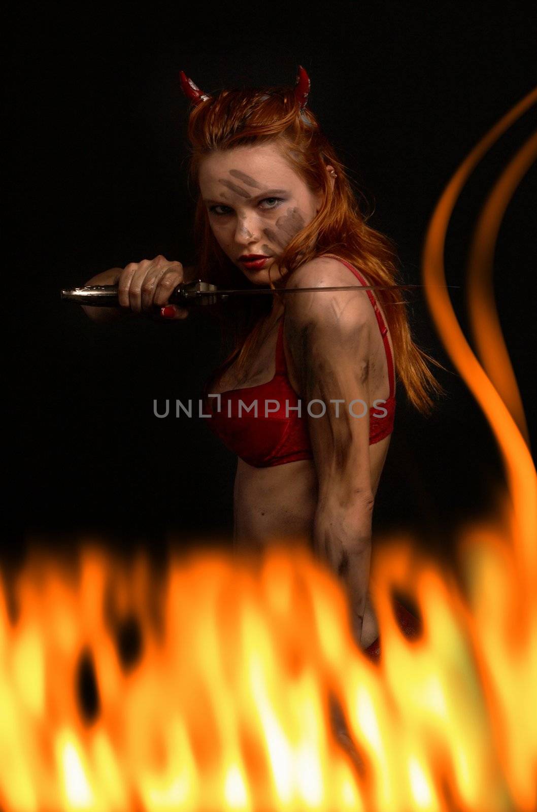 dark red devil girl with a knife in fire by dolgachov
