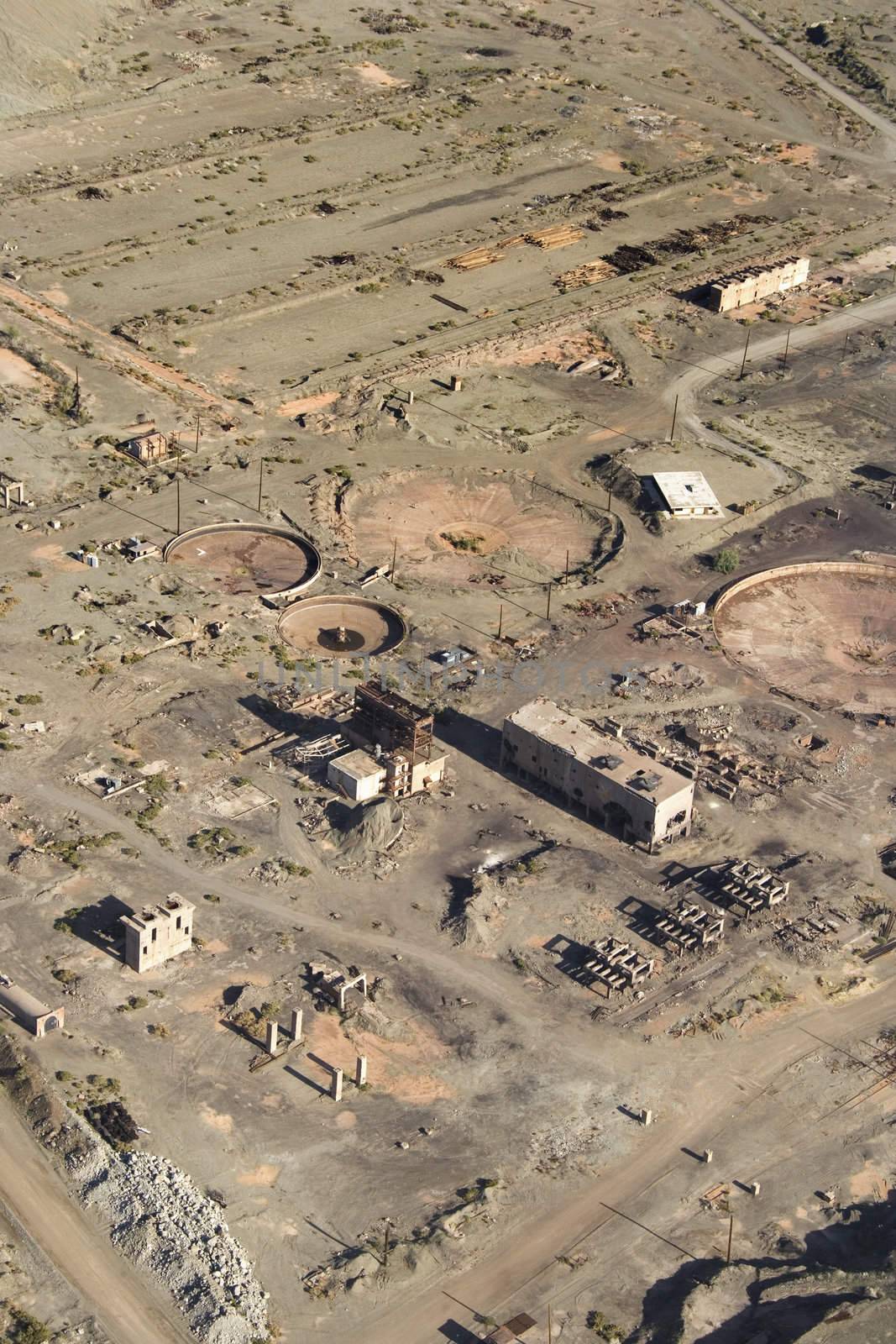 Aerial view of abandoned industrial facility in state of disrepair.