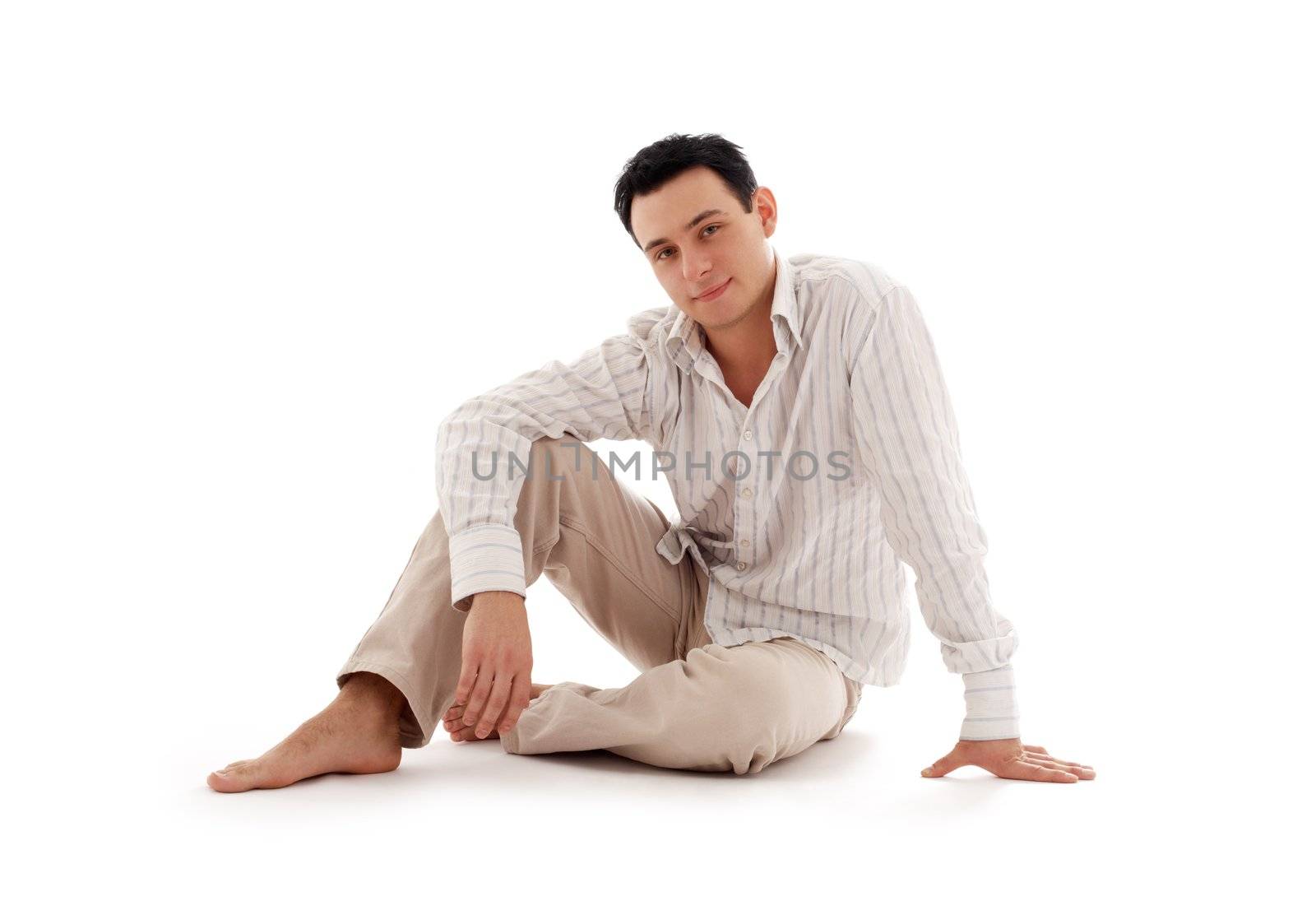 relaxed man sitting on the floor by dolgachov