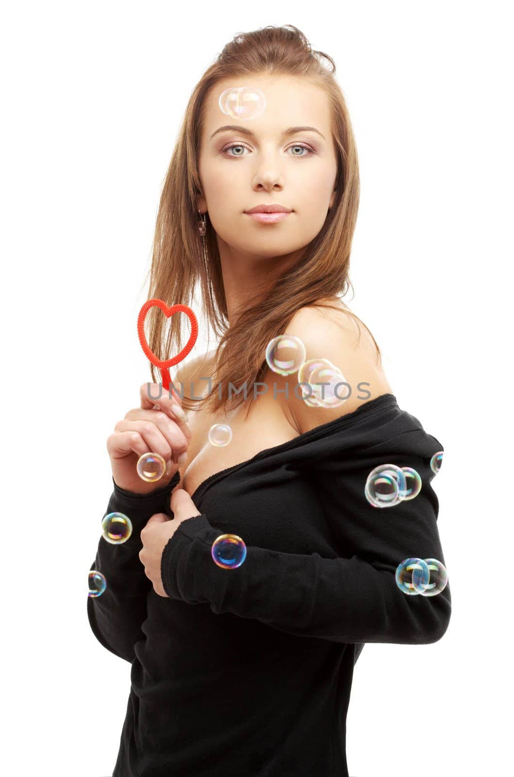 lovely girl with heart-shaped blower and soap bubbles