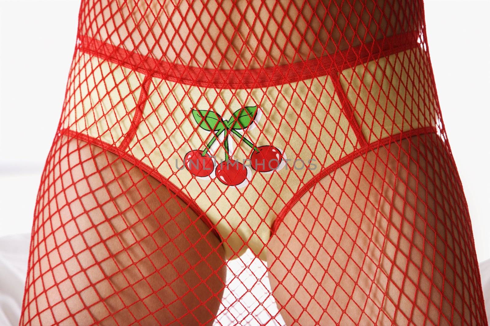 Caucasian woman wearing briefs with cherries and mesh covering body.